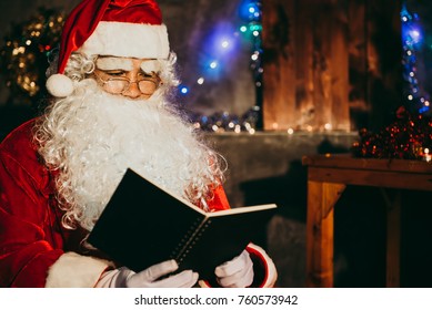 Santa claus read a book at night in the house,The light from the book,Using the light from the lantern room - Powered by Shutterstock