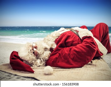 Santa Claus Relaxes Lying On The Beach