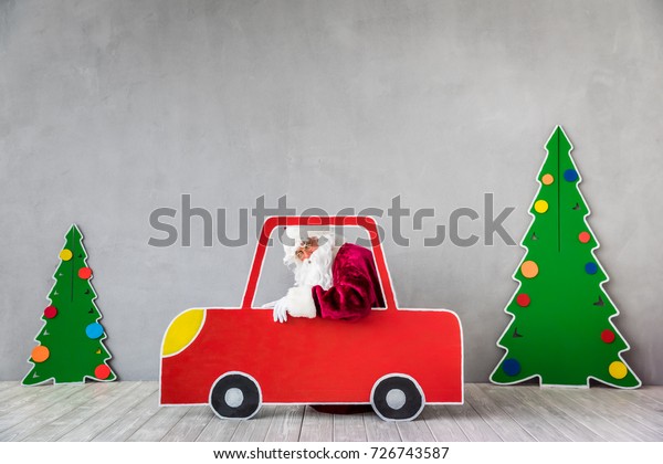 Santa\
Claus riding car. Christmas Xmas holiday\
concept