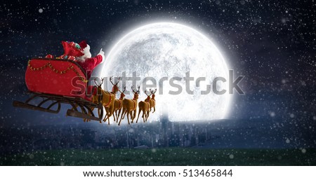 Santa Claus riding on sleigh with gift box against bright moon over city