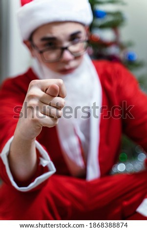 santa claus shows fig. focus on the hand. spoiled christmas. cancellation of New Year's holidays. Christmas in quarantine due to coronavirus
