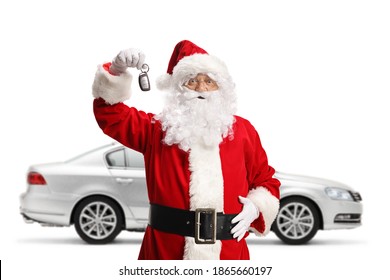 Santa Claus with a silver car showing keys and smiling isolated on white background - Powered by Shutterstock