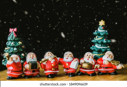 Santa Claus Sing A Song On Christmas Caroling Day Or Carolers Singing With Snows.Group Of Santa Claus Play Music Sing Carol Song On Celebration Of Christmas Day Party In Winter.Celebration Holidays.