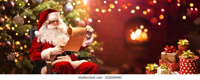 Santa Claus Sitting at His Room at Home Near Christmas Tree and Reading Christmas Letter or Wish List - Powered by Shutterstock