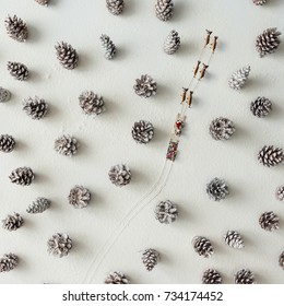 Santa claus sleigh and reindeer in snowy winter forest made of pinecones. Minimal christmas concept. Flat lay.
