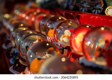 Santa Claus snowglobe set on a red velvet cloth sold at a booth of the Christmas market of the Champs Elysées in Paris, France - Handmade christmas decorations collection - Powered by Shutterstock