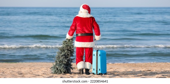 Santa Claus with suitcase and Christmas tree at sea resort - Powered by Shutterstock