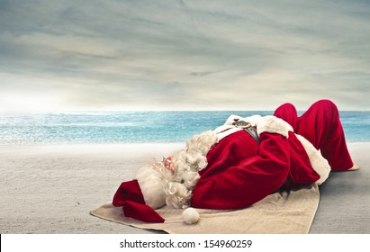 Santa Claus Sunbathing Lying On The Beach