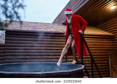 Santa Claus Testing Water Temperature In Vat