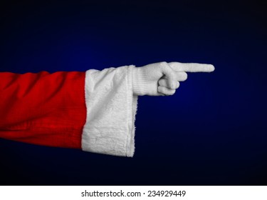 Santa Claus Theme: Santa's Hand Showing Gesture On A Dark Blue Background