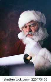 Santa Claus Unhappy Looking At Christmas Naught And Nice List