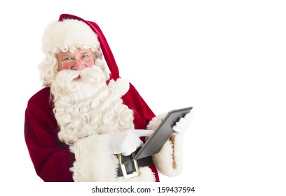 Santa Claus using digital tablet - Powered by Shutterstock