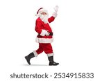 Santa Claus walking and waving at camera isolated on white background 