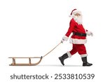 Santa Claus walking with a wooden sled and looking at camera isolated on white background 