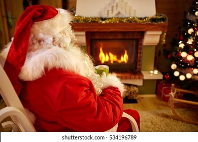 Santa Claus Warm Up With  Lemon Tea Near Fireplace