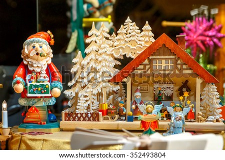 Santa Claus and wooden house at a Christmas souvenir market shop, decorated and illuminated in Bruges, Belgium 