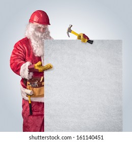 Santa Claus worker in helmet with poster on an isolated background