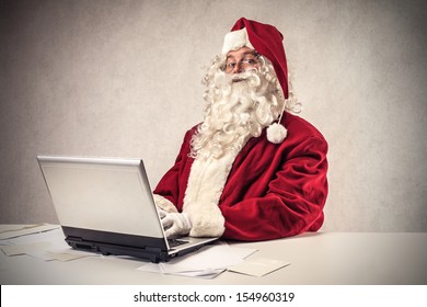 Santa Claus Working With The Computer