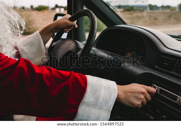Santa\
Claus working as a delivery man while listing\
music