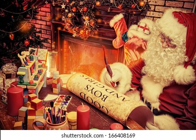 Santa Claus Writing A List Of Good Boys And Girls At Home. Christmas.