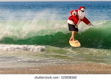 Santa Clause Catching A Wave On A Beautiful Beach. Santa Hang Ten. Santa Surfing;