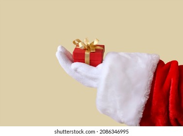 Santa Claus's Hand Holds A Christmas Gift