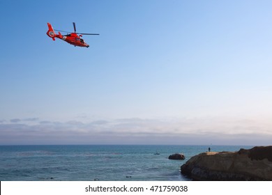 SANTA CRUZ, CALIFORNIA - AUGUST 20, 2016: A US Coast Guard Helicopter Responds To An Emergency Search And Rescue Incident Near Ocean Cliffs On August 20, 2016 In Santa Cruz, California.