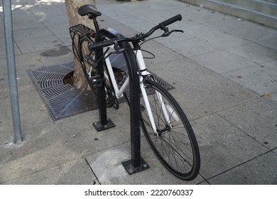 Santa Cruz, California, USA. ‎Sunday, ‎August ‎29, ‎2022. A Bicycle Locked To A Bike Rack On A City Sidewalk.