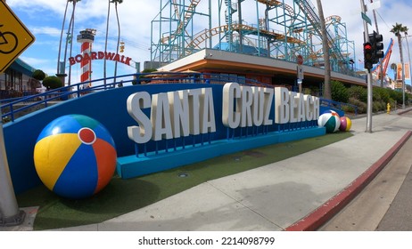 Santa Cruz, California, USA, June 30, 2022: Sign At The Entrance To The Santa Cruz Beach Boardwalk In The Morning. Beach Sign With Colorful Beach Balls And A Rollercoaster In The Background.