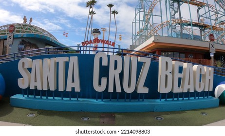 Santa Cruz, California, USA, June 30, 2022: Sign At The Entrance To The Santa Cruz Beach Boardwalk In The Morning. Beach Sign With Colorful Beach Balls And A Rollercoaster In The Background.