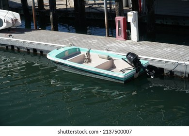 Santa Cruz, California, USA. Monday, ‎March ‎14, ‎2022. A small fiberglass power boat tied to a dock.