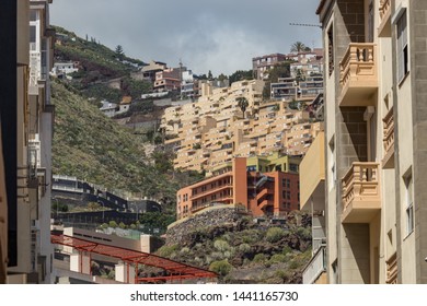 SANTA CRUZ, TENERIFE, SPAIN - March 20, 2018. Typical Narrow Streets In The Modern Part Of The City. Buildings On Steep Slopes. Long Focus Lens. Blurred Foreground. Capital Of Tenerife.