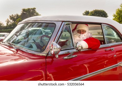 Santa Driving In Red Vintage Car