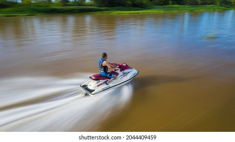 Santa Fe, Argentina, Jan 11, 2020: Man Riding A Jetski In A River. Drone Slow Shutter Photography.