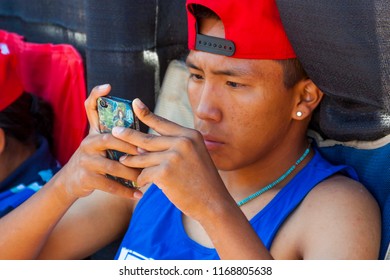 SANTA FE, NEW MEXICO, USA - AUGUST 18, 2013: Santa Fe Indian Market,  Native American Teen Using Cell Phone, Annual Event