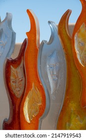 Santa Fe, New Mexico, U.S.A.-April 17,2022; Faces In Colorful Orange White And Yellow Glass Of Art Installation By Raya Friday At Santa Fe Botanical Gardens Vertical Format Room For Type