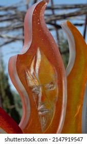 Santa Fe, New Mexico, U.S.A.-April 17,2022; Faces In Colorful Orange White And Yellow Glass Of Art Installation By Raya Friday At Santa Fe Botanical Gardens Vertical Format Room For Type