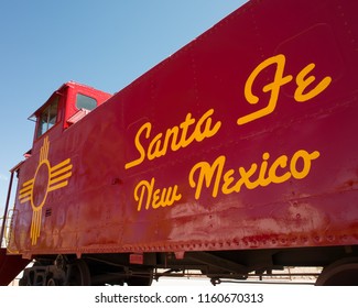 Santa Fe, New Mexico/USA- July 16, 2018: Old train caboose for the Atchison, Topeka and Santa Fe Railway (AT&SF) is decorated with the Zia state sun symbol.