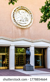 Santa Fe, USA - June 14, 2019: Capitol building in downtown center of city with entrance sign seal and statue by doors and nobody