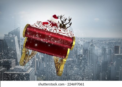 Santa flying his sleigh against cityscape