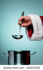 The Santa Hand Holding A Ladle Or Kitchen Spoon