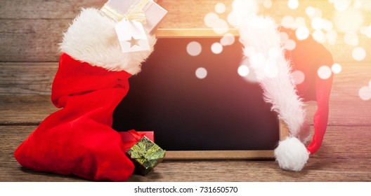 Santa hat and stocking arranged on slate during Christmas time - Powered by Shutterstock