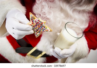 Santa Holding Cookies And Milk