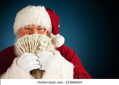 Santa: Holding Up Fanned Out Handful Of Cash