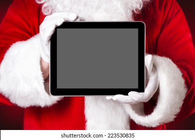 Santa holding a tablet with blank space - Powered by Shutterstock