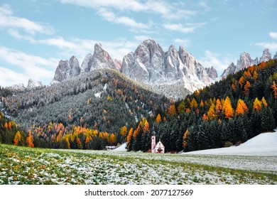 Santa Maddalena Village Church at the autumn Dolomite Alps. Amazing landscape with small chapel on snowy meadow at Santa Magdalena commune. Dolomites, South Tyrol, Bolzano, Italy