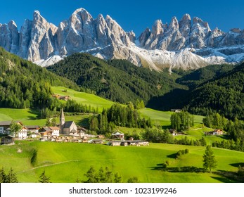 Santa Maddalena village in front of the Geisler or Odle Dolomites Group, Val di Funes, Val di Funes, Trentino Alto Adige, Italy, Europe. Blue sky and green grass, Autumn, 2017