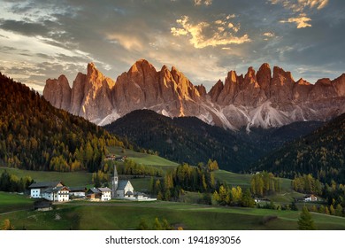 Santa Magdalena in Val di Funes with Odle dolomitic group on background at sunset. South Tyrol in Italy.