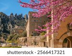 Santa Maria de Montserrat monastery in Montserrat mountains near Barcelona during spring season, Catalonia, Spain. Montserrat monastery, abbey of the Order of Saint Benedict.