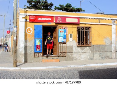 SANTA MARIA, SAL, CAPE VERDE, AFRICA - December 21, 2017. Mini Market Store Front And Shopping Man, Purchasing Local Food In Small Supermarket Grocery With Logo, Traditional Rustic Neighborhood Shop